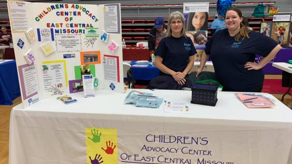 Children's advocacy center table and booth at community event